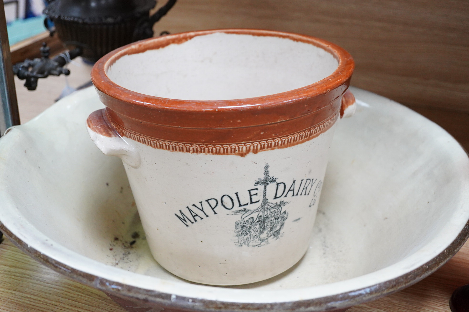 A glazed pottery dairy bowl and Maypole Dairy Co. Ltd. cream advertising cream pail, 21cm high (2)